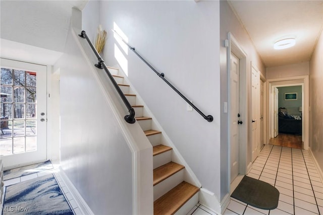 stairway with tile patterned flooring and baseboards