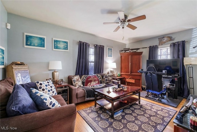 living area with wood finished floors and ceiling fan