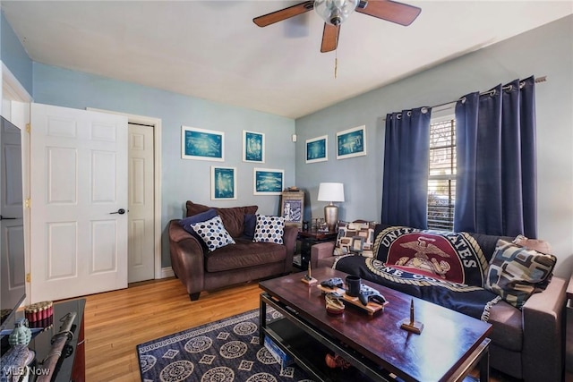 living room with wood finished floors and ceiling fan