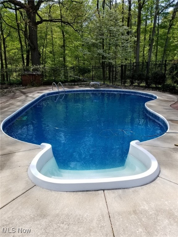 view of pool with a fenced in pool and fence