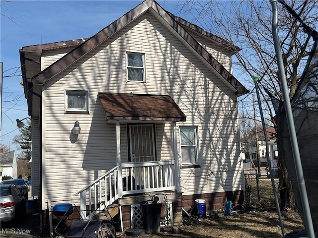 rear view of property with fence