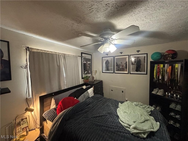 bedroom with a textured ceiling and ceiling fan