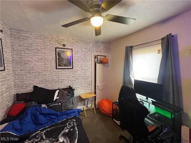 carpeted bedroom featuring a textured ceiling, brick wall, and a ceiling fan