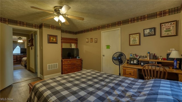 bedroom with visible vents, wood finished floors, a textured ceiling, and ceiling fan