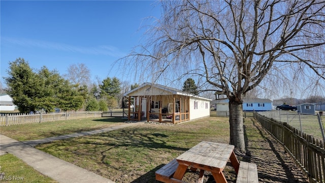 view of yard featuring an outbuilding and a fenced backyard