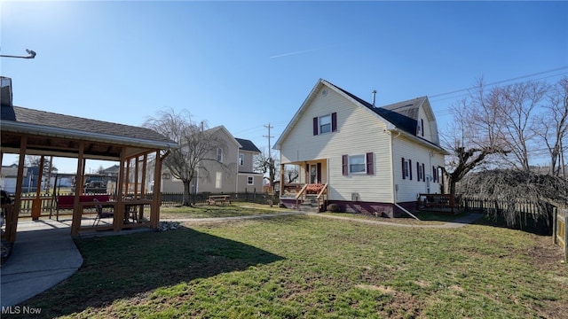 exterior space featuring a lawn and fence