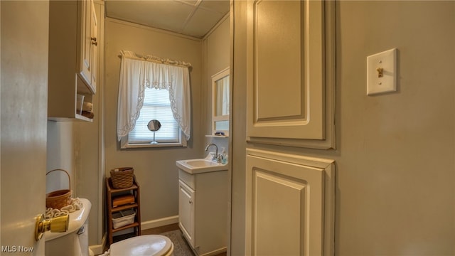 bathroom with baseboards, toilet, and vanity