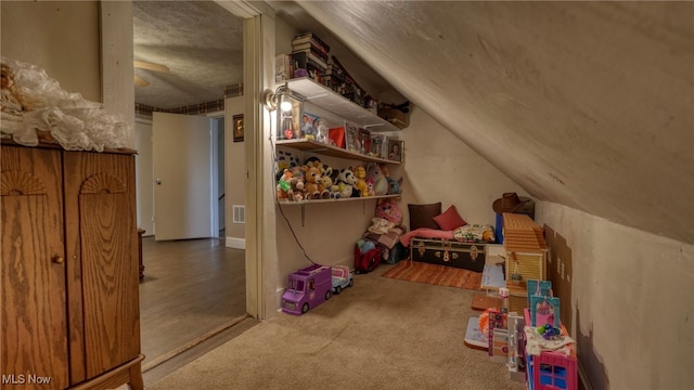 additional living space with visible vents, carpet floors, a ceiling fan, and vaulted ceiling