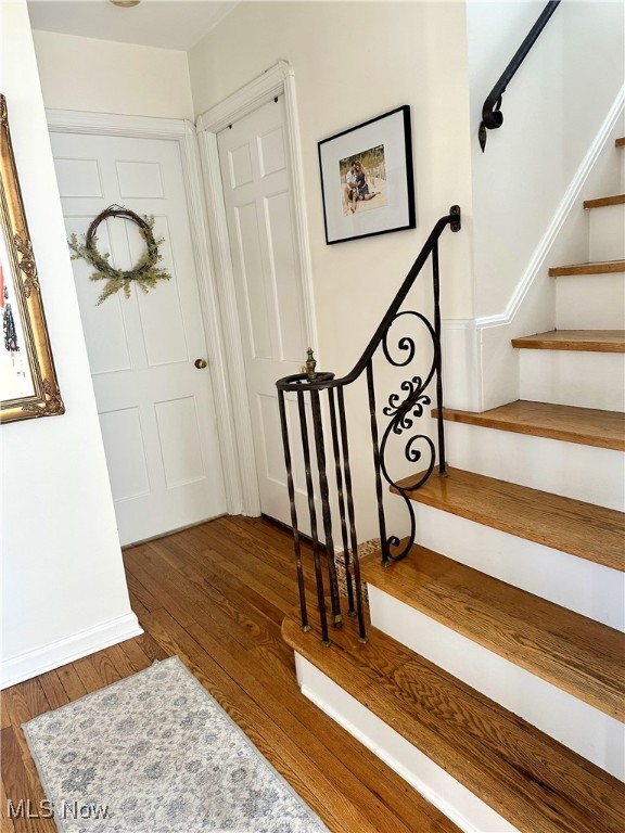 entryway with stairs and hardwood / wood-style flooring