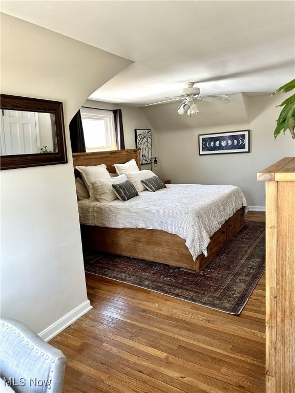 bedroom featuring ceiling fan, baseboards, and wood-type flooring