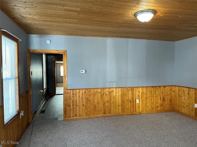 2046 Ohio Ave, East Liverpool, OH 43920 - spare room with a wainscoted wall, visible vents, carpet floors, wood walls, and wood ceiling