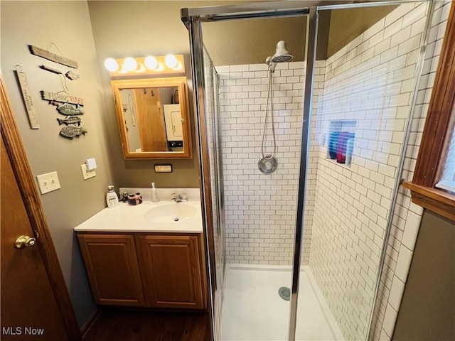 full bathroom with a stall shower and vanity