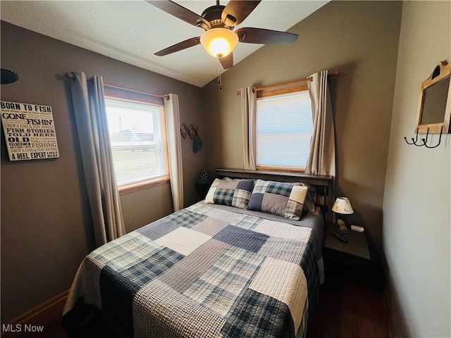 bedroom with baseboards, wood finished floors, a ceiling fan, and vaulted ceiling