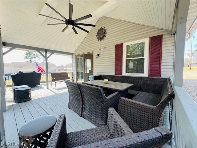 wooden terrace featuring outdoor dining space and a ceiling fan