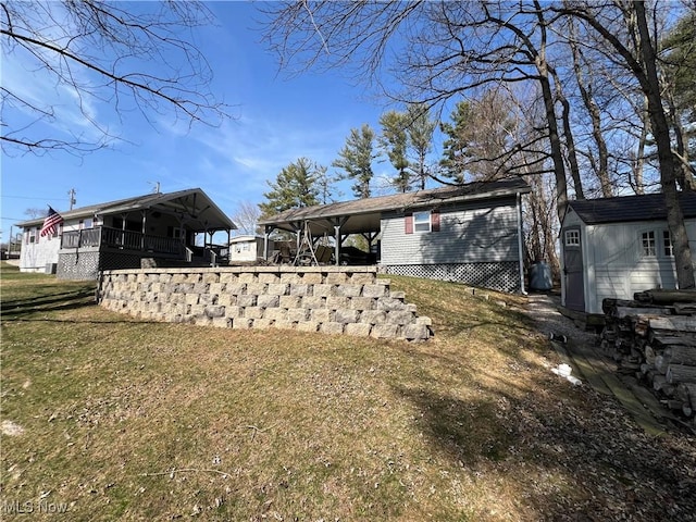 back of house with a carport and a lawn