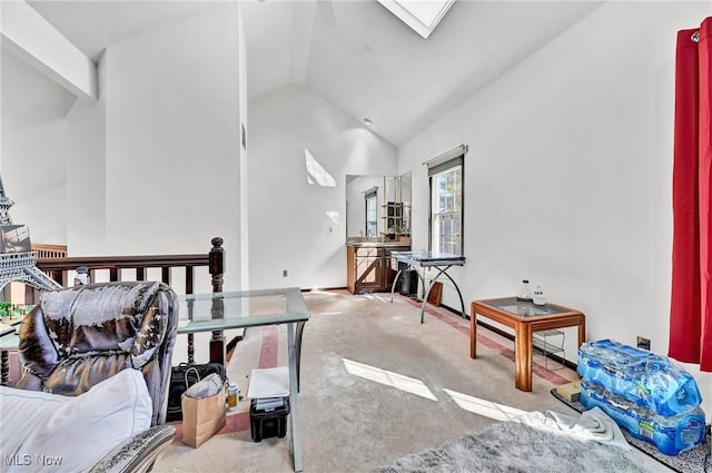 interior space featuring lofted ceiling with skylight and carpet flooring