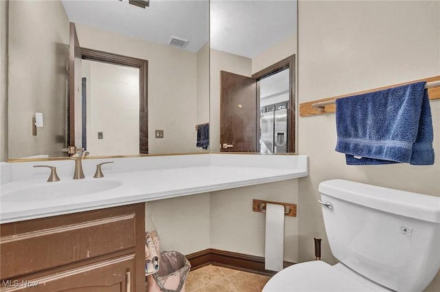 half bath featuring tile patterned floors, visible vents, toilet, and vanity