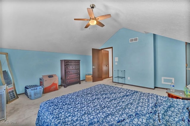 carpeted bedroom with visible vents, a ceiling fan, and vaulted ceiling