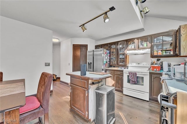 kitchen featuring light wood finished floors, white electric stove, stainless steel fridge with ice dispenser, under cabinet range hood, and a center island