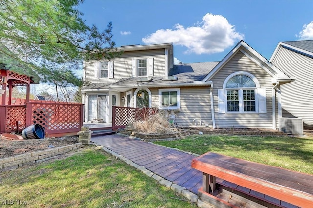 traditional-style house with a wooden deck and a front yard