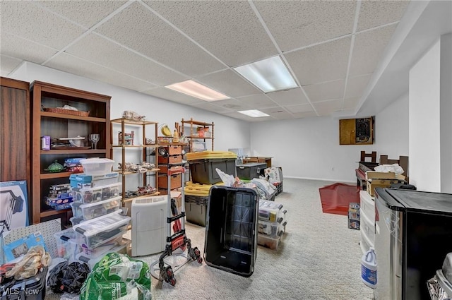 interior space featuring a paneled ceiling and baseboards