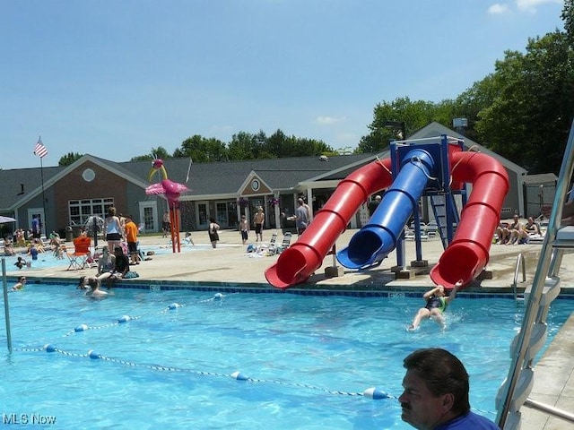 view of jungle gym featuring a community pool