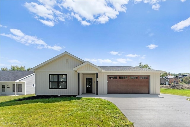 view of front of home featuring an attached garage, concrete driveway, a front yard, and board and batten siding