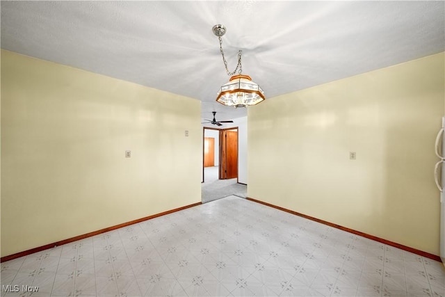 empty room featuring light floors, baseboards, and ceiling fan