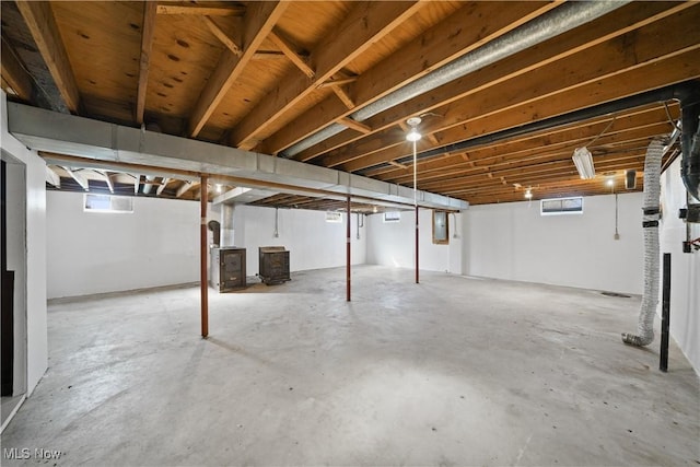 below grade area featuring electric panel and a wood stove