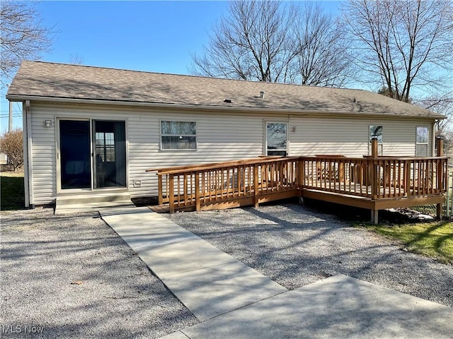 back of house featuring a deck and a shingled roof