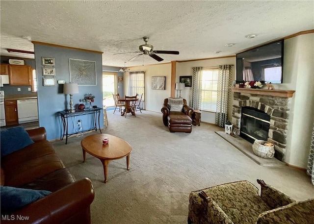 living area with carpet flooring, plenty of natural light, crown molding, and a ceiling fan