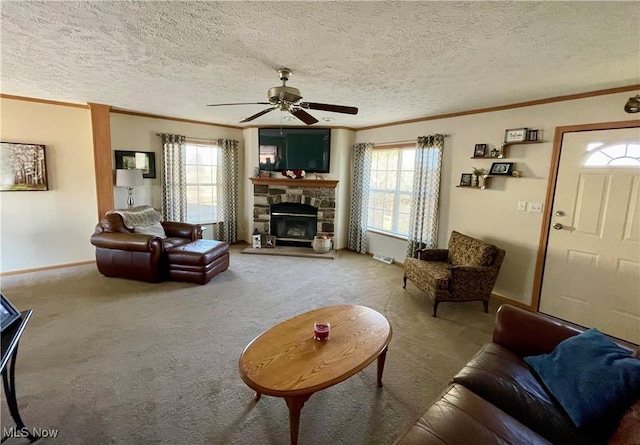 carpeted living room featuring a wealth of natural light, crown molding, and a ceiling fan