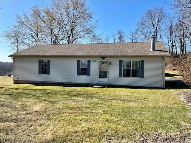 ranch-style house featuring entry steps, a front yard, and roof with shingles