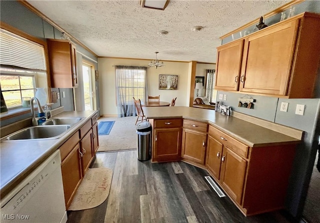 kitchen with a sink, dishwasher, ornamental molding, and dark wood-style flooring