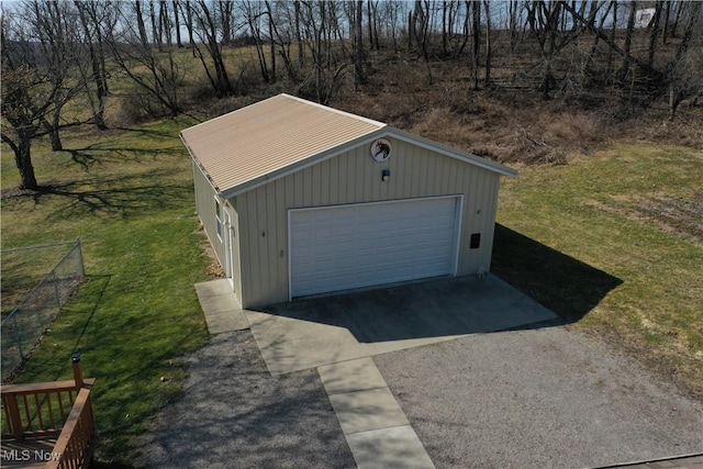 detached garage featuring fence