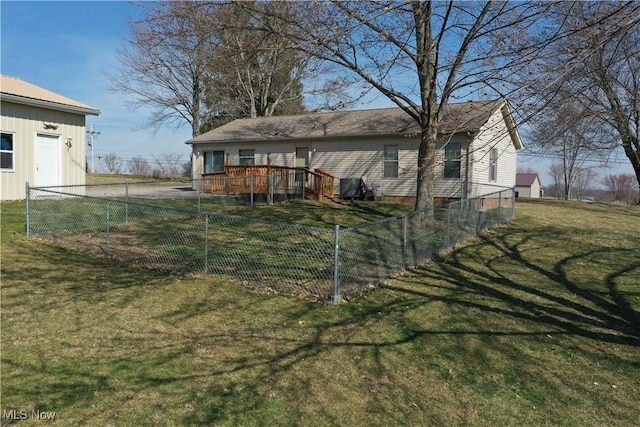 rear view of house featuring a yard, a deck, and fence