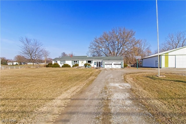 view of front facade with a front yard and driveway