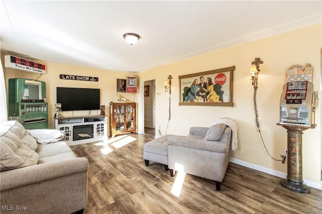 living area featuring baseboards and wood finished floors