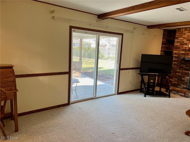 living area with beamed ceiling, carpet floors, baseboards, and visible vents