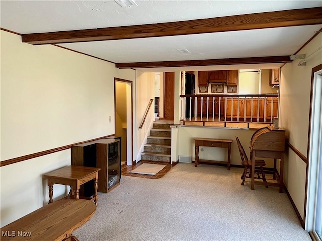 interior space featuring beam ceiling, light colored carpet, stairs, and baseboards