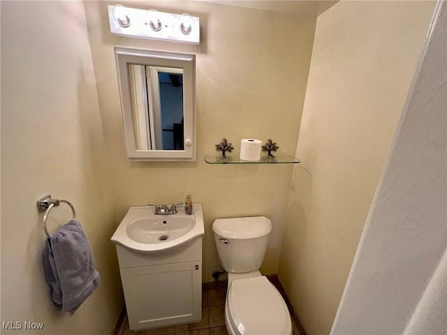 bathroom featuring vanity, toilet, and tile patterned flooring