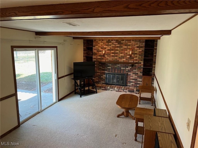 unfurnished living room with beamed ceiling, visible vents, baseboards, a brick fireplace, and carpet flooring