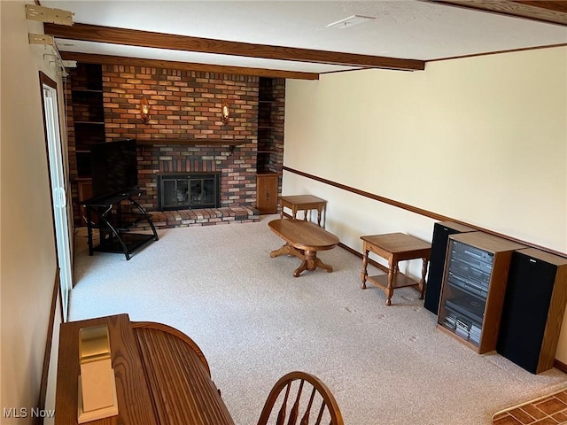 unfurnished living room with baseboards, beam ceiling, a brick fireplace, and carpet flooring