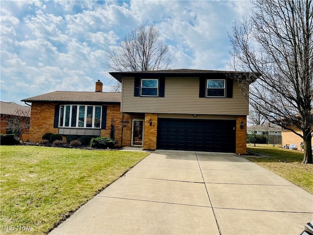 tri-level home featuring brick siding, driveway, an attached garage, and a front lawn