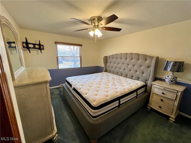 bedroom featuring dark colored carpet, baseboards, and ceiling fan