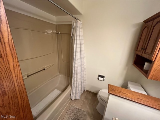 bathroom with tile patterned floors, toilet, and shower / bath combo