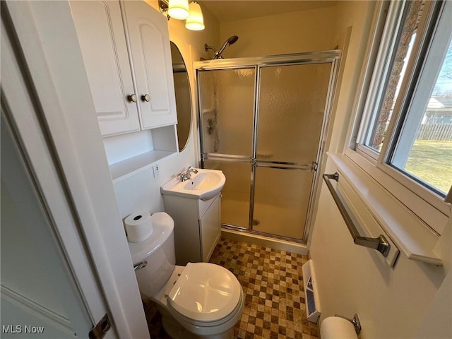 bathroom with vanity, a shower stall, toilet, and tile patterned floors