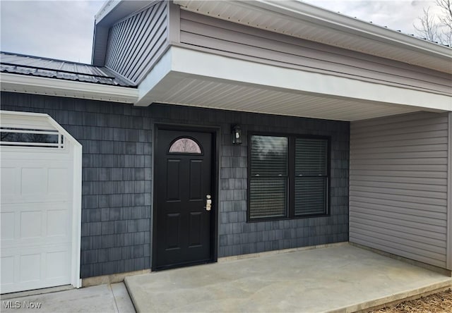 entrance to property featuring an attached garage