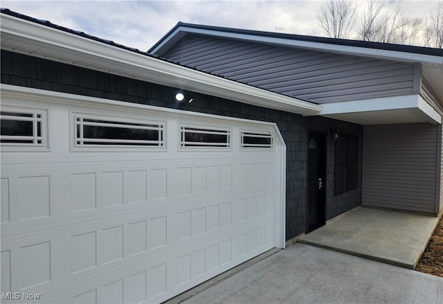 garage featuring concrete driveway