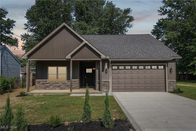 craftsman inspired home featuring a garage, stone siding, covered porch, and driveway